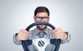 Funny bearded man in glasses with a steering wheel Royalty Free Stock Photo