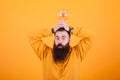 Funny bearded man with a light bulb over his head in front over yellow background Royalty Free Stock Photo