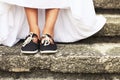Funny beautiful bride wearing blue running shoes