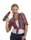 Funny beautiful girl with a drill drills head