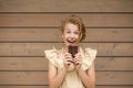 Funny beautiful Girl with ginger hair and freckles holding chocolate. Her face is dirty. But she laughs it is fun and delicious. Royalty Free Stock Photo