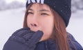 Beauty attractive woman with winter fashion clothing is making funny face in snow skii resort bitting her hand