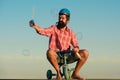 Funny bicycle rider. Comic man ride bike. Funny biker. Guy riding a small bicycle. Royalty Free Stock Photo