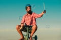 Funny bicycle rider. Comic man ride bike. Funny biker. Guy riding a small bicycle. Royalty Free Stock Photo