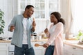 Funny Black Couple Singing And Dancing In Kitchen, Using Utensils As Microphones Royalty Free Stock Photo