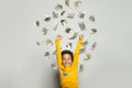 Funny black kid boy with us dollar money rain on grey background Royalty Free Stock Photo