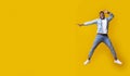 Funny black man jumping and pointing at copy space with hand Royalty Free Stock Photo
