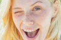 Funny blonde women wink portrait close up. Beauty blonde girl. Portrait of beautiful woman model with natural skin. Royalty Free Stock Photo