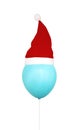 Funny blue air helium balloon with red christmas santa hat Royalty Free Stock Photo