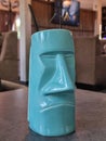 Funny blue glass for cocktails in caffe with man sculptured face