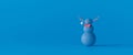 Funny blue snowman with reindeer antlers on blue background. Winter Holidays concept