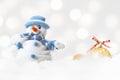 Funny blue snowman on xmas lights bokeh background, white snowflakes, merry Christmas and happy new year card concept Royalty Free Stock Photo