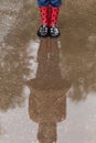 Funny boots feel like a ladybug and reflection in a puddle.