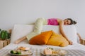 Funny bored woman lie on sofa waiting for her boyfriend in a boring day.