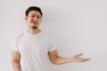 Funny bored and disappointed face man in white t-shirt isolated on white wall.