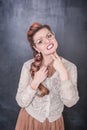 Funny bored woman holding two fingers near throat on chalkboard