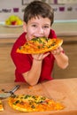 Funny boy eating the big piece of pizza Royalty Free Stock Photo