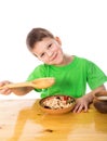 Funny boy eating oatmeal