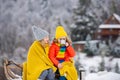 Funny boy and girl having fun with a sleigh in winter. Cute children playing in a snow. Winter activities for kids. Royalty Free Stock Photo