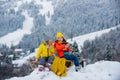 Funny boy and girl having fun with a sleigh in winter. Cute children playing in a snow. Winter activities for kids. Royalty Free Stock Photo