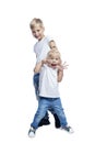 Funny boy and girl. Little brother and sister in white T-shirts and jeans stand and laugh. Love and tenderness in the family. Royalty Free Stock Photo