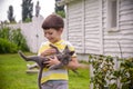 Funny boy hugging a cat with lots of love. Portrait of child hol Royalty Free Stock Photo