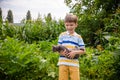 Funny boy hugging a cat with lots of love. Portrait of child holding on hands a Kitten. Playing with a cat on village countryside Royalty Free Stock Photo