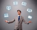 Funny boy juggling with electronic devices icons Royalty Free Stock Photo