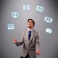 Funny boy juggling with electronic devices icons Royalty Free Stock Photo