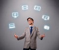 Funny boy juggling with electronic devices icons Royalty Free Stock Photo