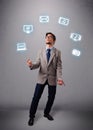 Funny boy juggling with electronic devices icons Royalty Free Stock Photo