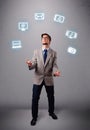 Funny boy juggling with electronic devices icons Royalty Free Stock Photo