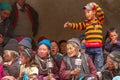 Funny boy and older ladakhi women with hand prayer wheels in traditional clothes and jewelry on Yuru Kabgyat festival