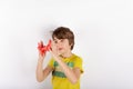 Funny boy playing with red slime looks like gunk Royalty Free Stock Photo
