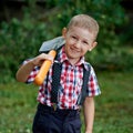 Funny boy with shovel in garden Royalty Free Stock Photo