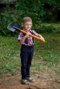 Funny boy with shovel in garden Royalty Free Stock Photo