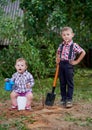 Funny boy with shovel in garden Royalty Free Stock Photo