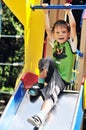 Funny boy on the slide Royalty Free Stock Photo