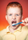 Funny boy with a toothbrush. Happy little boy brushing his teeth. Adorable little boy holding toothbrush and smiling at