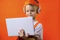 Funny boy in uniform builder and headphones looking laptop Royalty Free Stock Photo