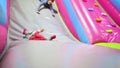 Funny boys playing on inflated slide