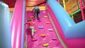 Funny boys playing on inflated slide