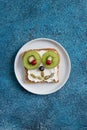 Funny breakfast toast for kids shaped as cute dog. Food art sandwich for child. Isolated. Animal faces toasts with spreads, fruits Royalty Free Stock Photo