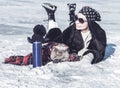 Funny British fluffy cat and a girl in sunglasses and a bandana on their heads are fishing