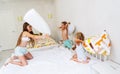 Funny brother and sister fighting pillow on bed morning bedroom kids boy and girl playing together Royalty Free Stock Photo