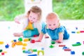 Funny brother and sister playing with colorful blocks Royalty Free Stock Photo