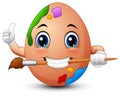 Funny brown easter egg painter gives a thumbs up while biting a brush Royalty Free Stock Photo