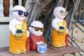 Funny Buddhist statues of monks in orange and red robes, Buddhist temple, donation to the temple Royalty Free Stock Photo