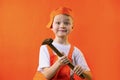Funny builder boy in uniform holds a hammer Royalty Free Stock Photo