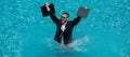 Funny business man in business suit with laptop jumping in splash water in the pool. Remote work. Crazy freelancer Royalty Free Stock Photo